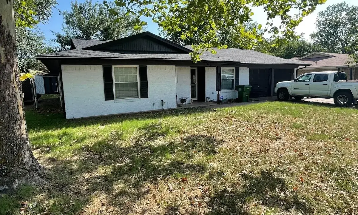 Professional roofing crew working on a residential roof in Brownstown